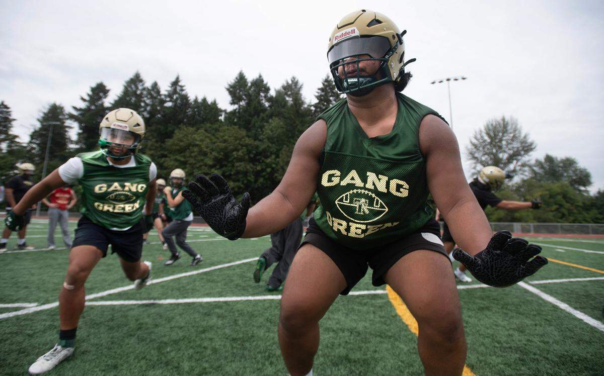 Timberline lineman Kingslen Tuianna-Morris runs through plays during preseason football practice at Timberline High School in Lacey, Washington, on Thursday, Aug. 22, 2024.