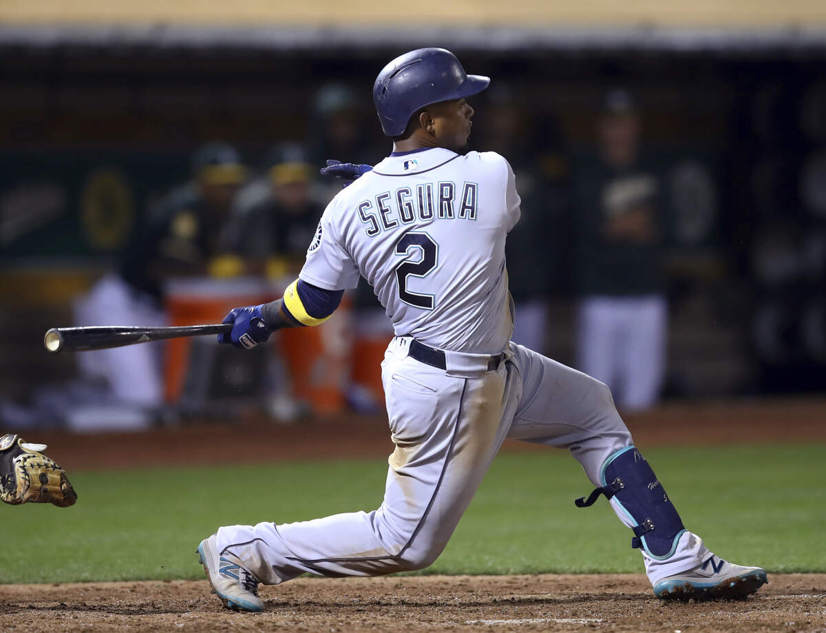 Seattle Mariners’ Jean Segura follows through on a two-run single off Oakland Athletics’ Cory Gearrin during the fifth inning of a baseball game Saturday, Sept. 1, 2018, in Oakland, Calif. (AP Photo/Ben Margot)