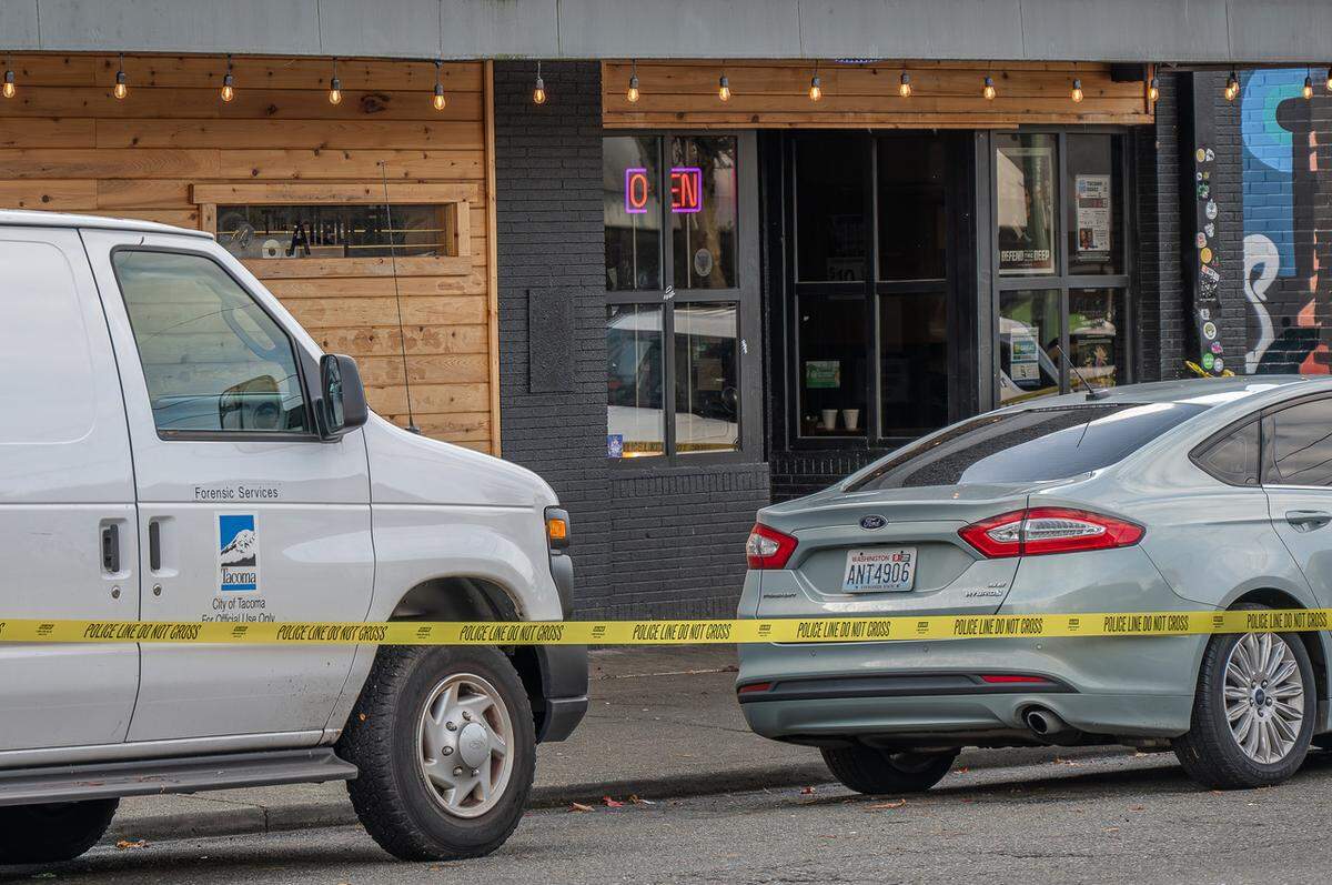 A Pierce County forensics services van was parked outside a 6th Avenue business on Sunday afternoon following an early-morning shooting that killed two and wounded three.