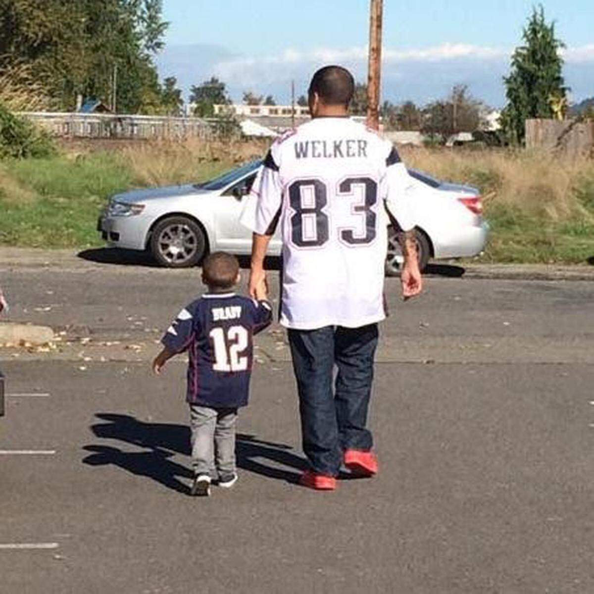 Nathan McWalters walking with his son ahead of Super Bowl XLIX in 2015.
