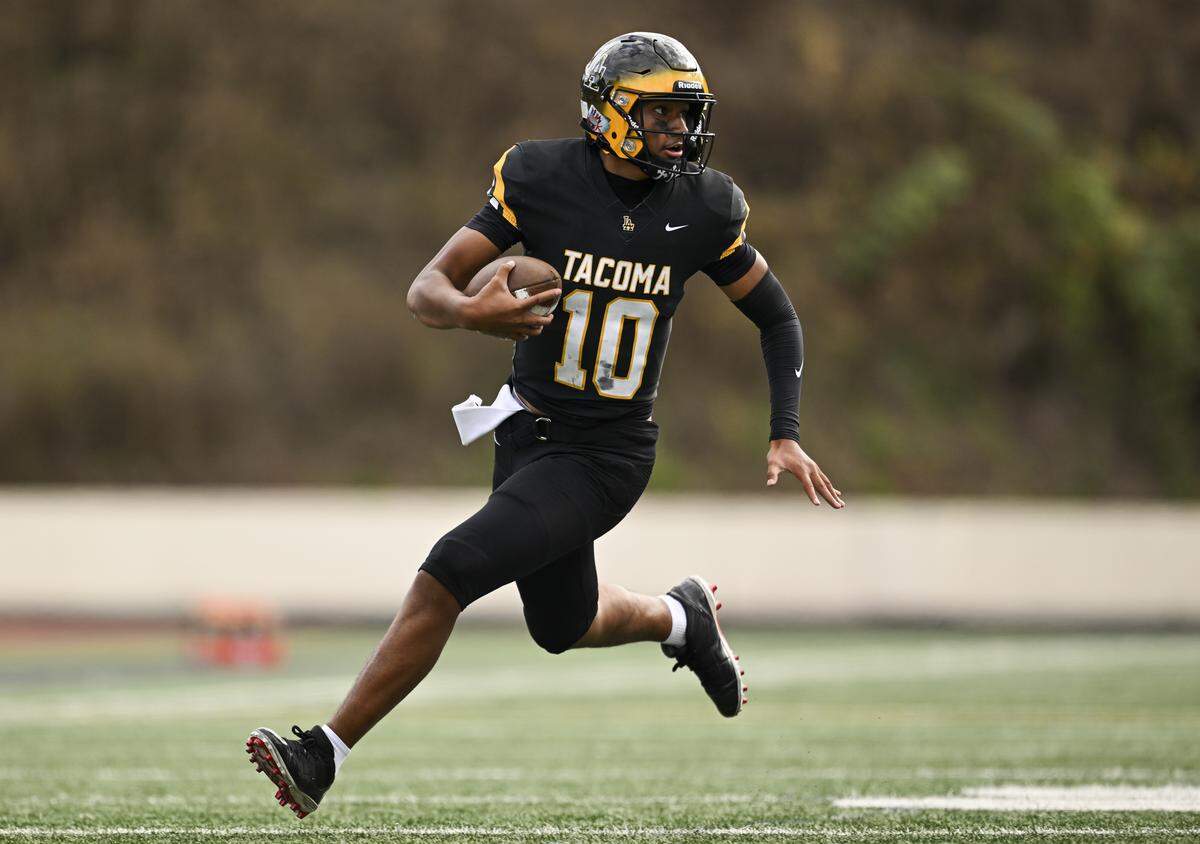 Lincoln quarterback Sione Kaho (10) keeps the ball during the first half of the game against the Mount Tahoma T-Birds at Lincoln High School, on Saturday, Oct. 4, 2025, in Tacoma, Wash.