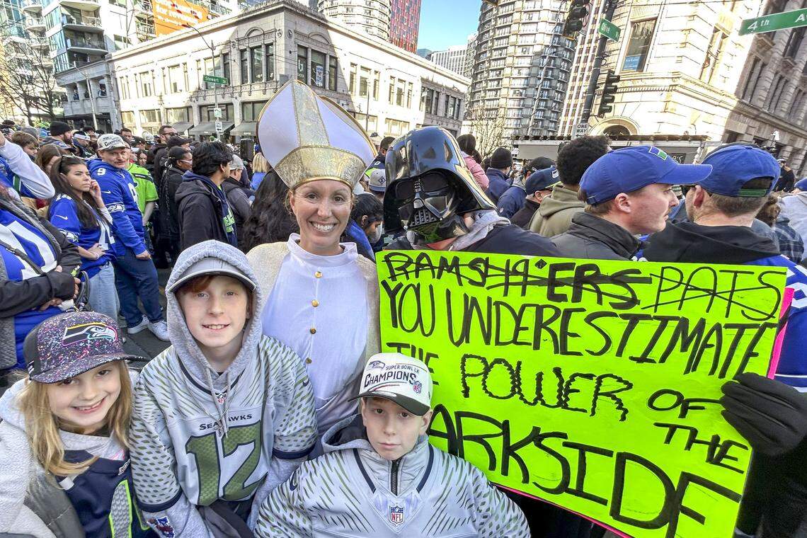 From left: Amelia Saty (7), TJ Saty (11), Caroline Saty (bishop outfit), Jack Saty (9) and Tyler Saty (Darth Vader) pose for a photo during the Seahawks Super Bowl parade in downtown Seattle on Wednesday, Feb. 11, 2026. They left their home in Vancouver, Washington, at 3 a.m. to get a spot along 4th Avenue for the show.