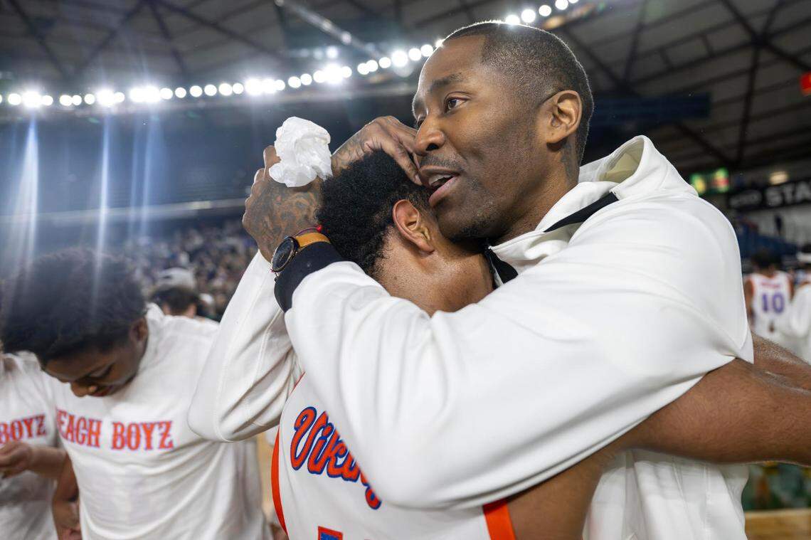 Jamal Crawford, a Rainier Beach graduate and former NBA player who is helping coach the his alma mater, hugs Rainier Beach guard Jaylen Petty (11) after the Vikings beat Edmonds-Woodway, 68-48, to win the Class 3A state championship at the Tacoma Dome on Saturday, March 8, 2025, in Tacoma, Wash.