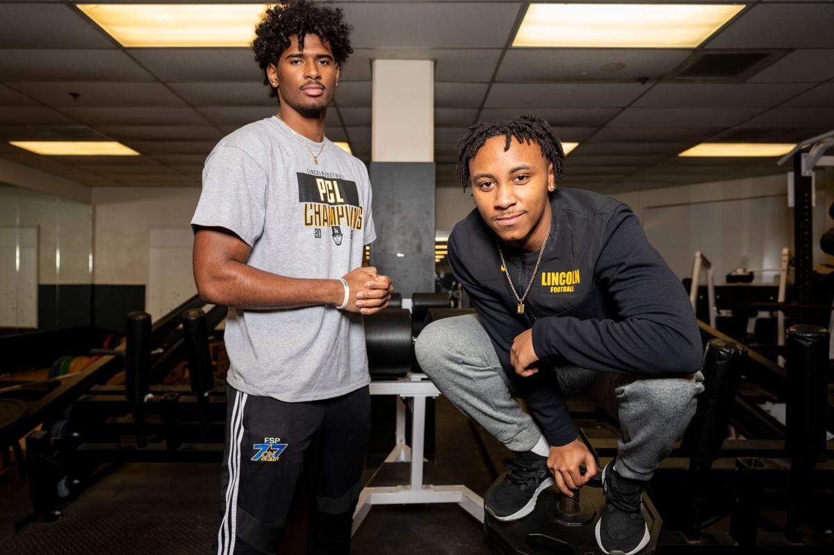Lincoln High School juniors Jayden Wayne (left) and Gabarri Johnson pose for a portrait in the high school’s weight room on Friday, Jan. 28, 2022, in Tacoma, Wash.