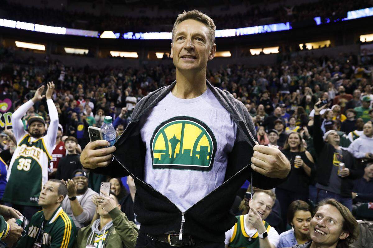 Oct 5, 2018; Seattle, WA, USA; Former Seattle Supersonics forward Detlef Schremph (11) shows off a Sonics t-shirt during a pregame between the Sacramento Kings and Golden State Warriors at KeyArena. Mandatory Credit: Joe Nicholson-USA TODAY Sports