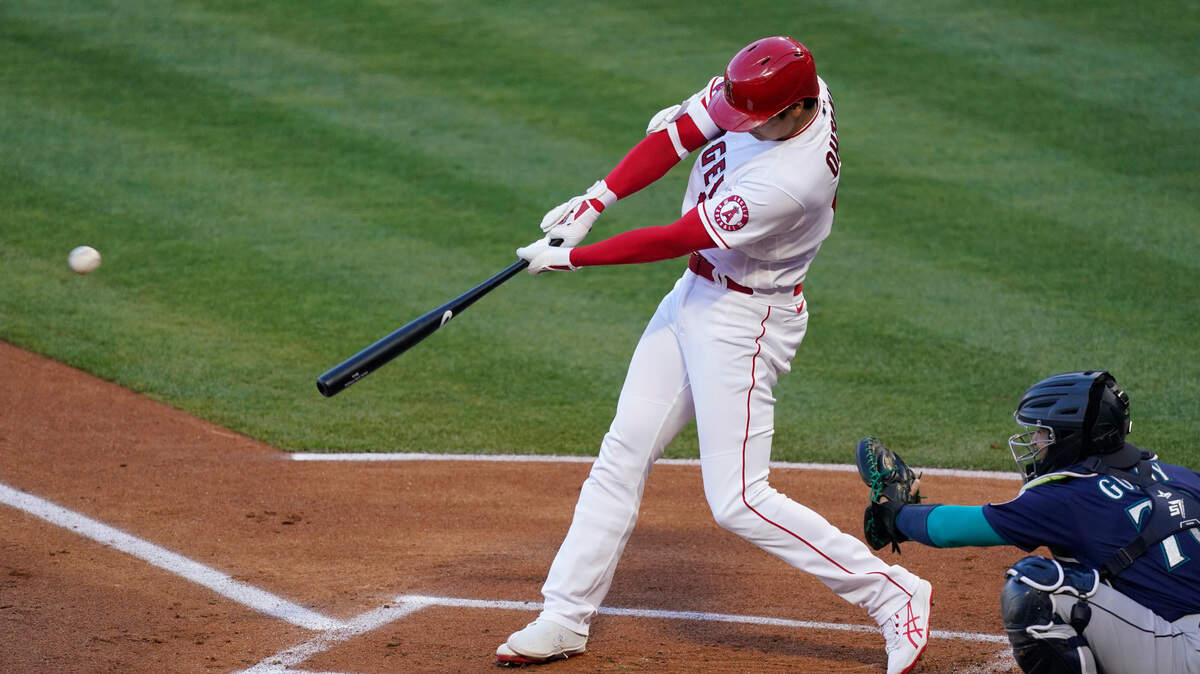 Los Angeles Angels designated hitter Shohei Ohtani (17) hits a home run during the first inning of a baseball game against the Seattle Mariners Saturday, June 5, 2021, in Anaheim, Calif. (AP Photo/Ashley Landis)