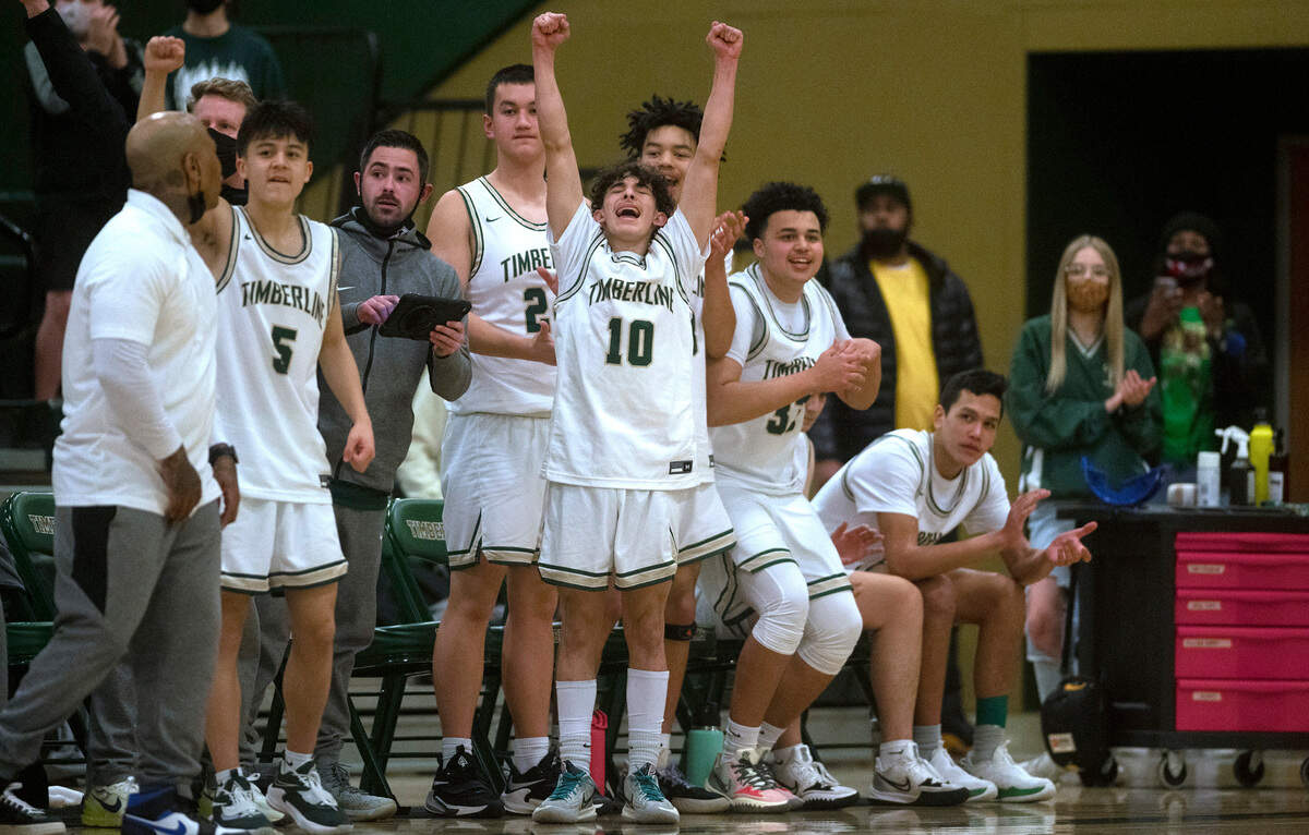 Timberline’s Eli Monteagudo-Rodriguez celebrates with the Blazer bench late in Friday night’s 3A South Sound Conference boys basketball game against Gig Harbor at Timberline High School in Lacey, Washington, on Jan. 14, 2022. Timberline rallied for the come-from-behind victory, 60-57.