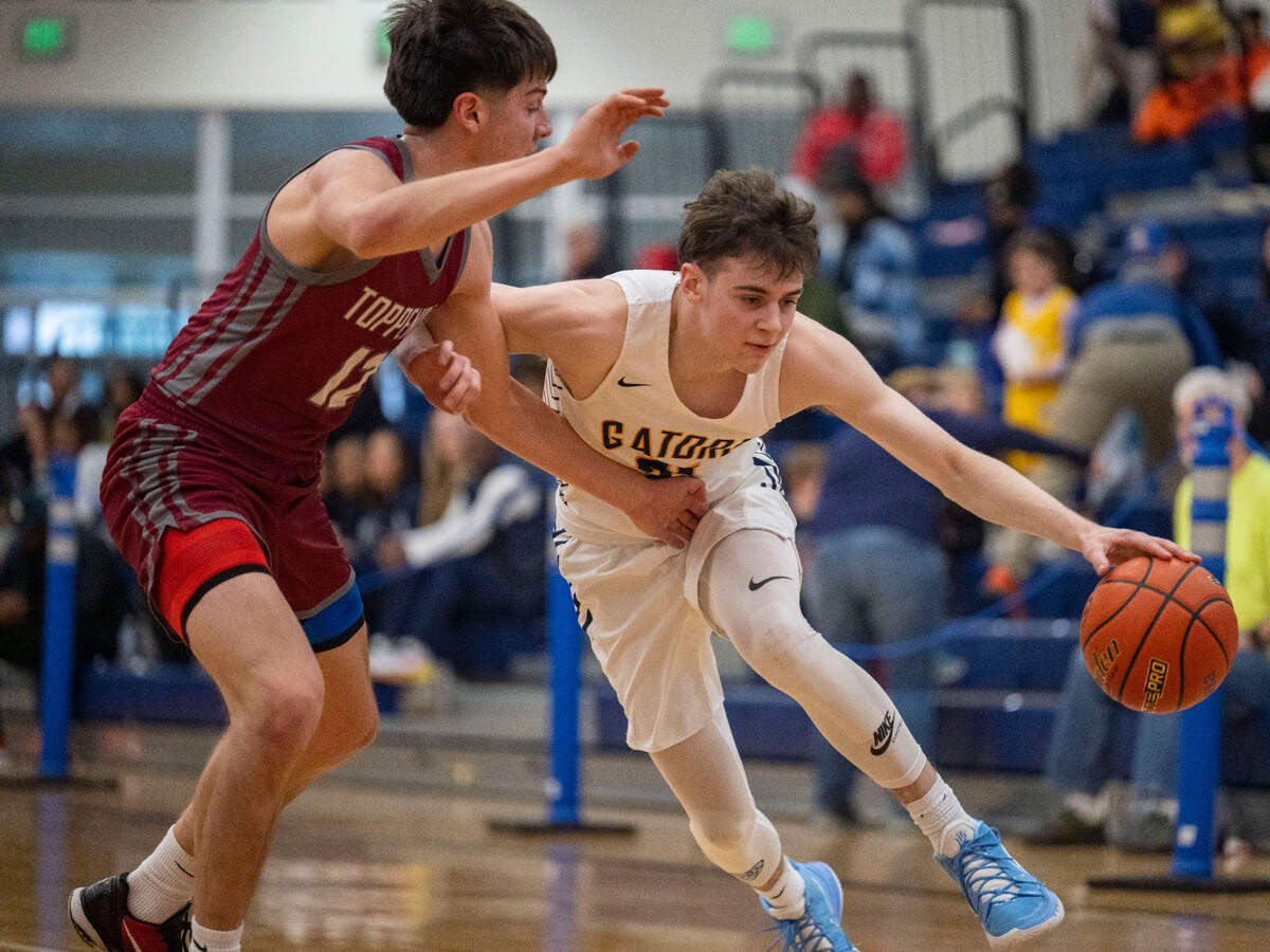 Annie Wright forward Martin Kaupanger (21) drives to the basket as Toppenish forward Shane Rivera (12) defends during the first quarter of a Class 1A state regionals game on Saturday, Feb. 25, 2023, at Tacoma Community College, in Tacoma, Wash.