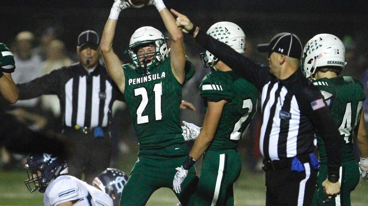 Peninsula’s Jude Endsley celebrates after coming up with the ball after a Gig Harbor fumble in the fourth quarter in the 40th Fish Bowl rivalry game between Peninsula and Gig Harbor high schools on Friday, Oct. 19, 2018.