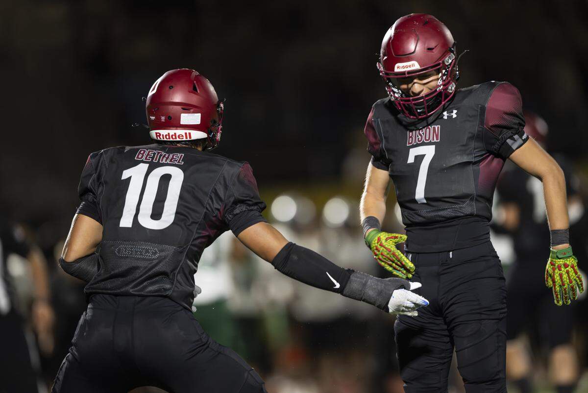 Bethel Bison linebacker Ramzak Fruean (10) and defensive back Nicholas Saucedo (7) react to a forced turnover against the Emerald Ridge Jaguars during the second half of the game at Art Crate Field on Thursday, Sept. 11, 2025, in Spanaway, Wash.