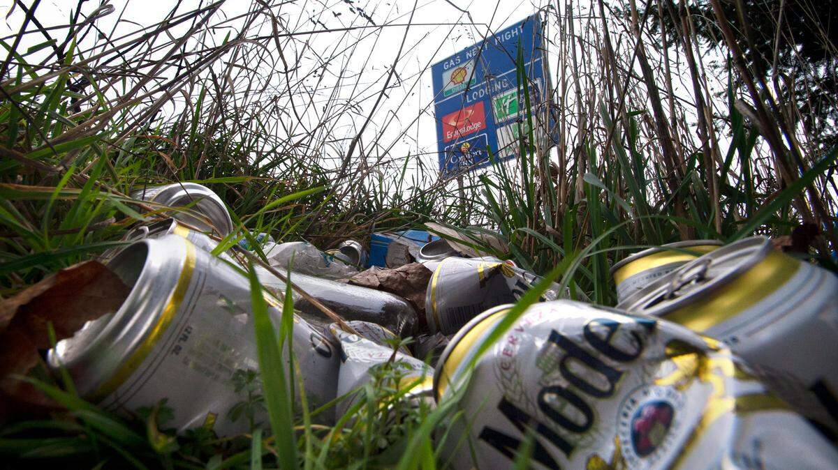 A pile of beer cans lies in the grass along Interstate 5 near Tacoma.