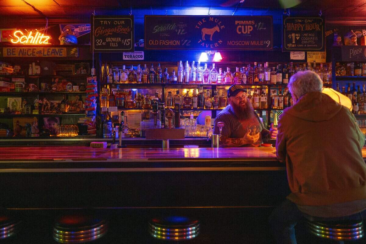 Bartender Kyle Mobley speaks with a guest at The Mule Tavern on Wednesday, July 8, 2026, in Tacoma, Wash.