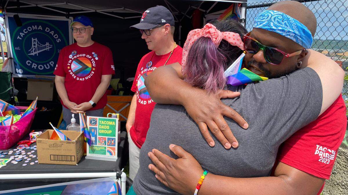 Jessie Keating of Tacoma gets a hug from Thomas Barcous at the Tacoma Pride festival Saturday afternoon. Barcous and his group, Tacoma Dads, were staffing a hug booth. “I just haven’t been around a dad in a long time,” Keating said.