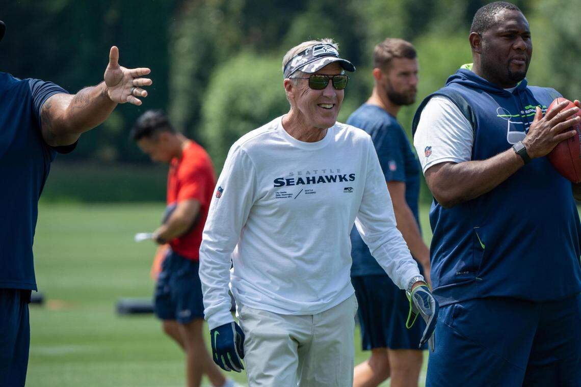 Seattle Seahawks coach Pete Carroll warms up with the team during the first day of training camp at the Virginia Mason Athletic Center on July 27, 2022.