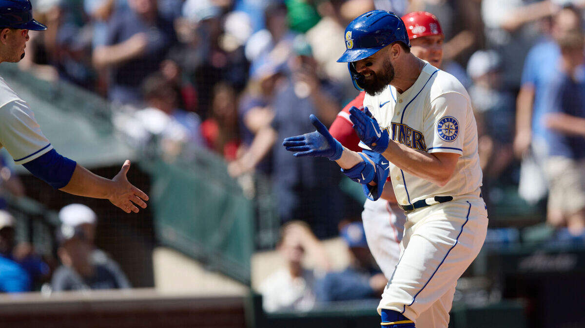 Seattle Mariners’ Jesse Winker celebrates as he heads home after hitting a grand slam against the Los Angeles Angels on a pitch from Tucker Davidson during third inning of a baseball game, Sunday, Aug. 7, 2022, in Seattle. (AP Photo/John Froschauer)