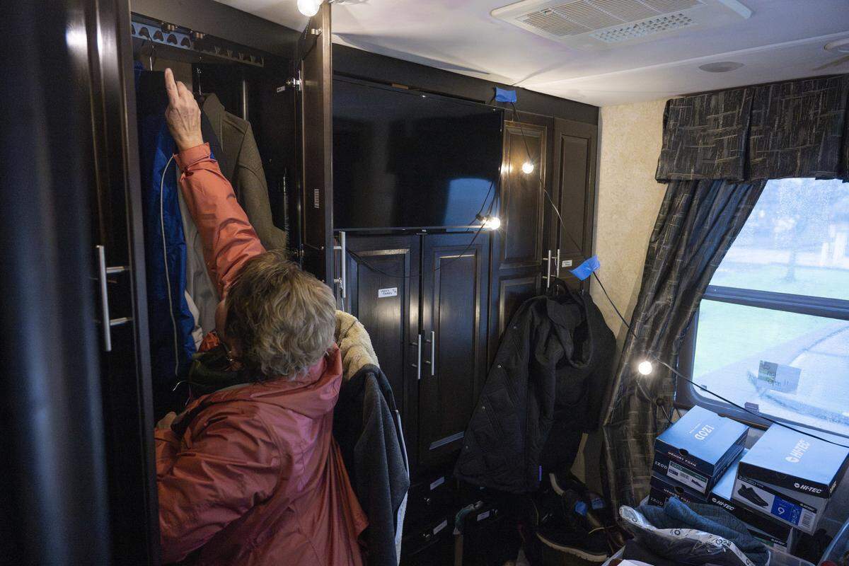 Volunteer Mary Kleinsasser looks through jacket options for a recently released detainee on Friday, March 20, 2026, outside of the Northwest ICE Processing Center in Tacoma, Wash. They are guided to the welcome center run by Advocates for Immigrants in Detention Northwest, where they are offered clothing, food, other supplies and assistance with travel.
