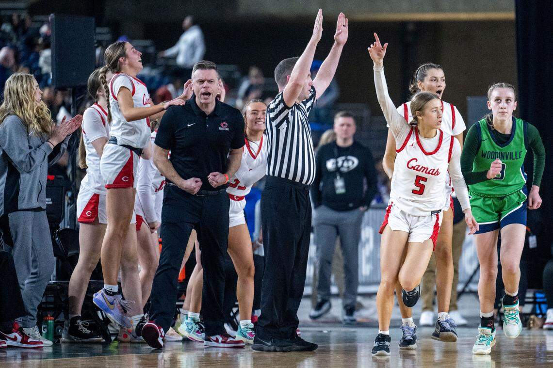 Camas forward Parker Mairs (5) celebrates after making a 3-pointer from the corner as Woodinville forward Lyla Kahrimanovic (3) jogs back on defense during the third quarter of a Class 3A quarterfinal game on Thursday, March 2, 2023, in Tacoma, Wash.