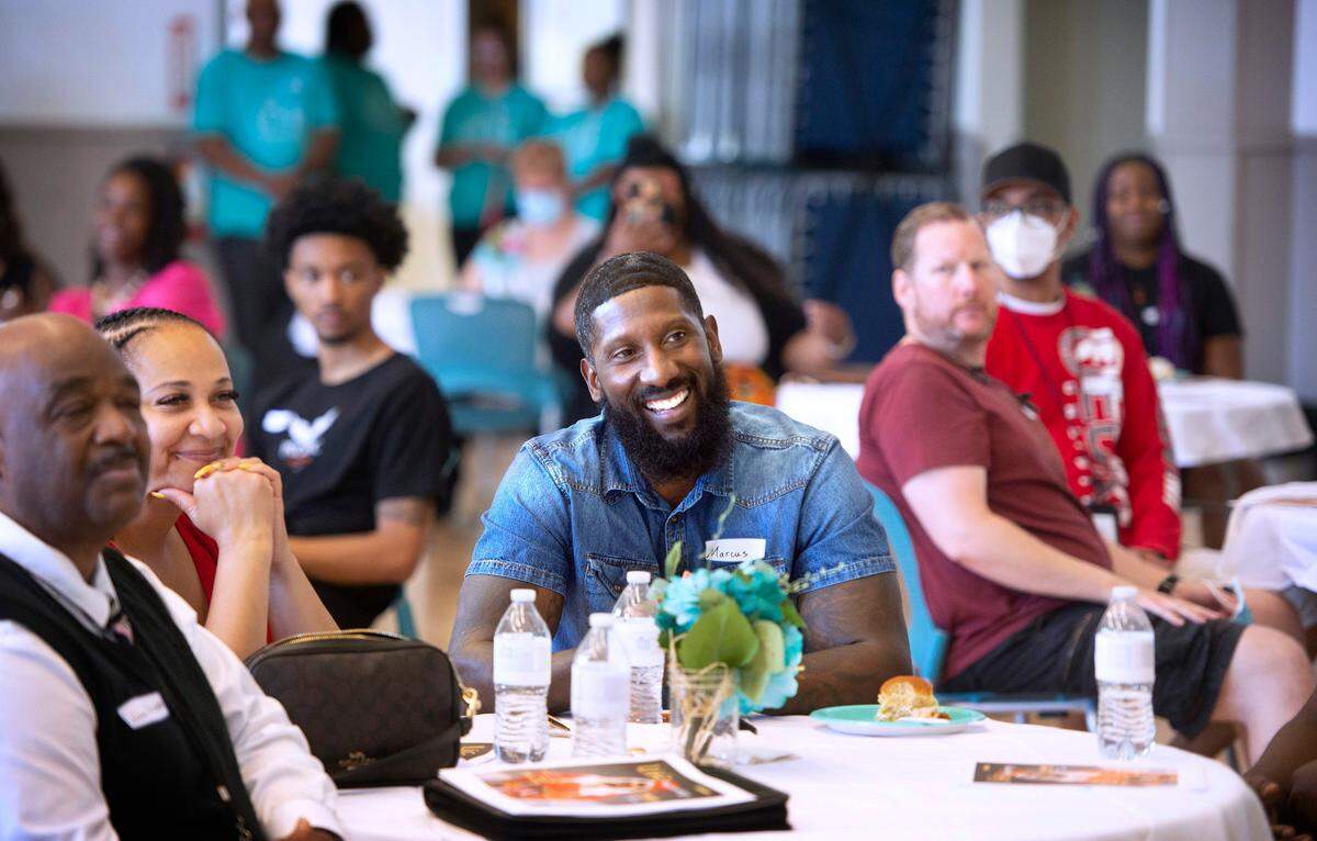 Former Seattle Seahawk Marcus Trufant listens to speakers during the public tour of the Life Enrichment Group’s new expanded homeless youth services at the Beacon Center in Tacoma on Wednesday, July 20, 2022.