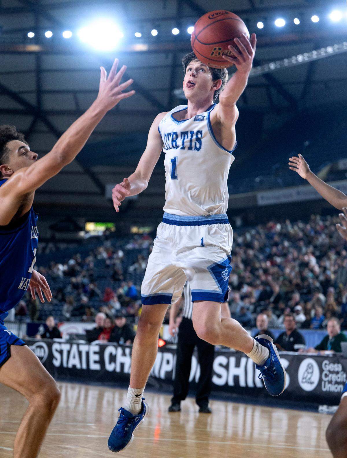 Curtis’ Tyce Paulsen flies to the hoop in front of Federal Way defender Dace Pleasant during their state semifinal game at the WIAA state basketball tournament in the Tacoma Dome in Tacoma, Washington, on Friday, March 3, 2023. Curtis won the game, 56-43.