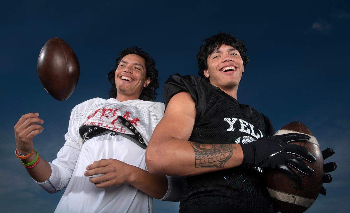 With senior Damian Aalona (left) at quarterback and twin brother Marius Aalona at wide receiver, the Yelm Tornados are putting up big offensive numbers with hopes of defending their 2022 state championship. The duo are photographed at Yelm High School on Wednesday, Sept. 13, 2023.