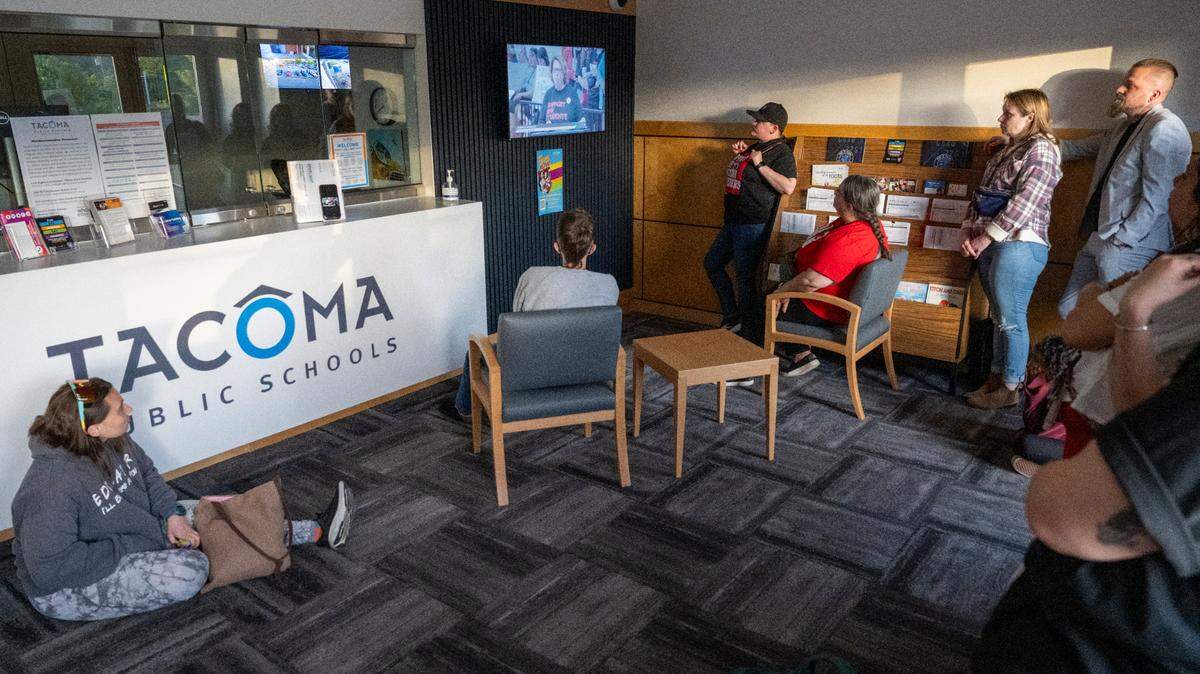 People gather in hallways and the entryway of the Tacoma Public Schools Central Administration Building to watch a board of directors meeting on Thursday, May 22, 2025, in Tacoma, Wash. The district could lose $2.6 million per year in President Donald Trump’s proposed budget for the Department of Education -- further exacerbating the district’s existing budget deficit.