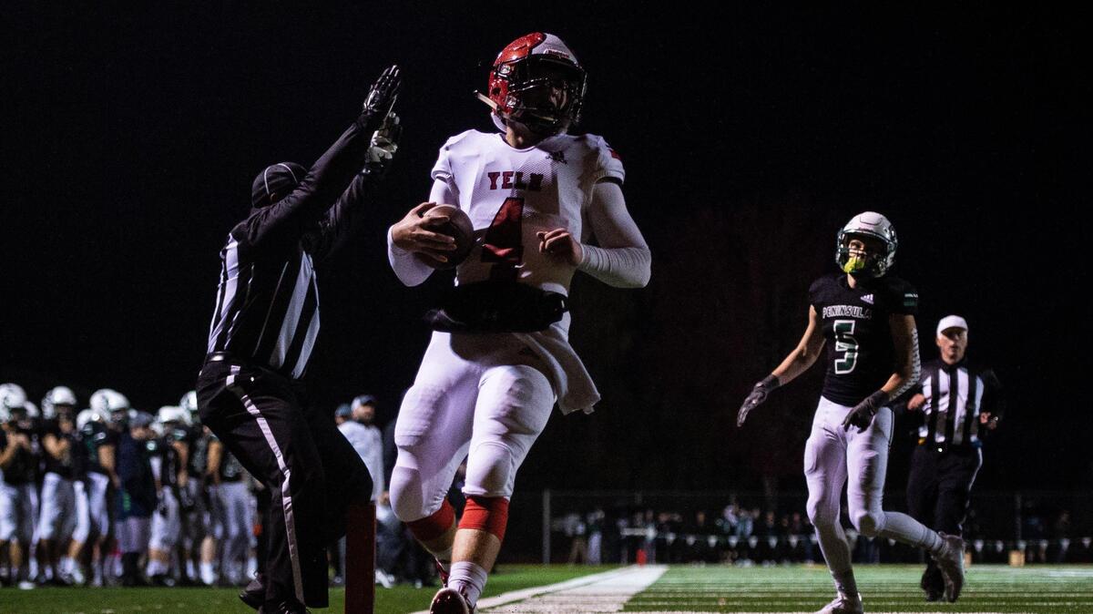 Yelm’s Benjamin Hoffmann scrambles into the end zone for a touchdown in the first quarter. Peninsula played Yelm in a football game at Roy Anderson Field in Purdy, Wash., on Friday, Oct. 18, 2019.