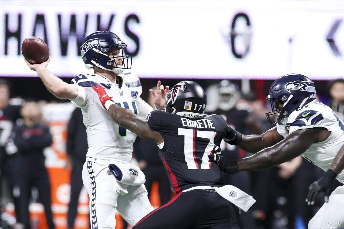 Sam Darnold (14) of the Seattle Seahawks attempts to throws a pass in front of Arnold Ebiketie (17) of the Atlanta Falcons during the first quarter at Mercedes-Benz Stadium on Dec. 7, 2025 in Atlanta.