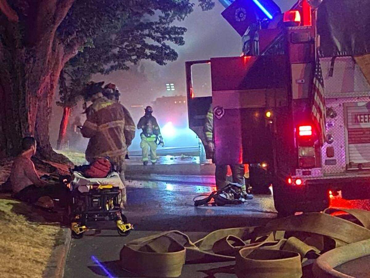 At least one Tacoma firefighter was transported from the scene by medical personnel Thursday night.