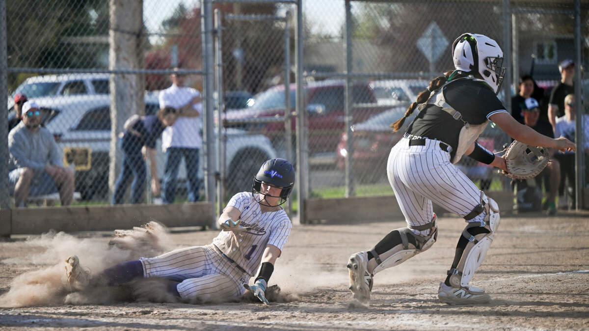 Puyallup’s Mack Hardesty (1) slides in to tie the game against Emerald Ridge during the softball game at Puyallup High School, on Friday, April 18, 2025, in Puyallup, Wash.