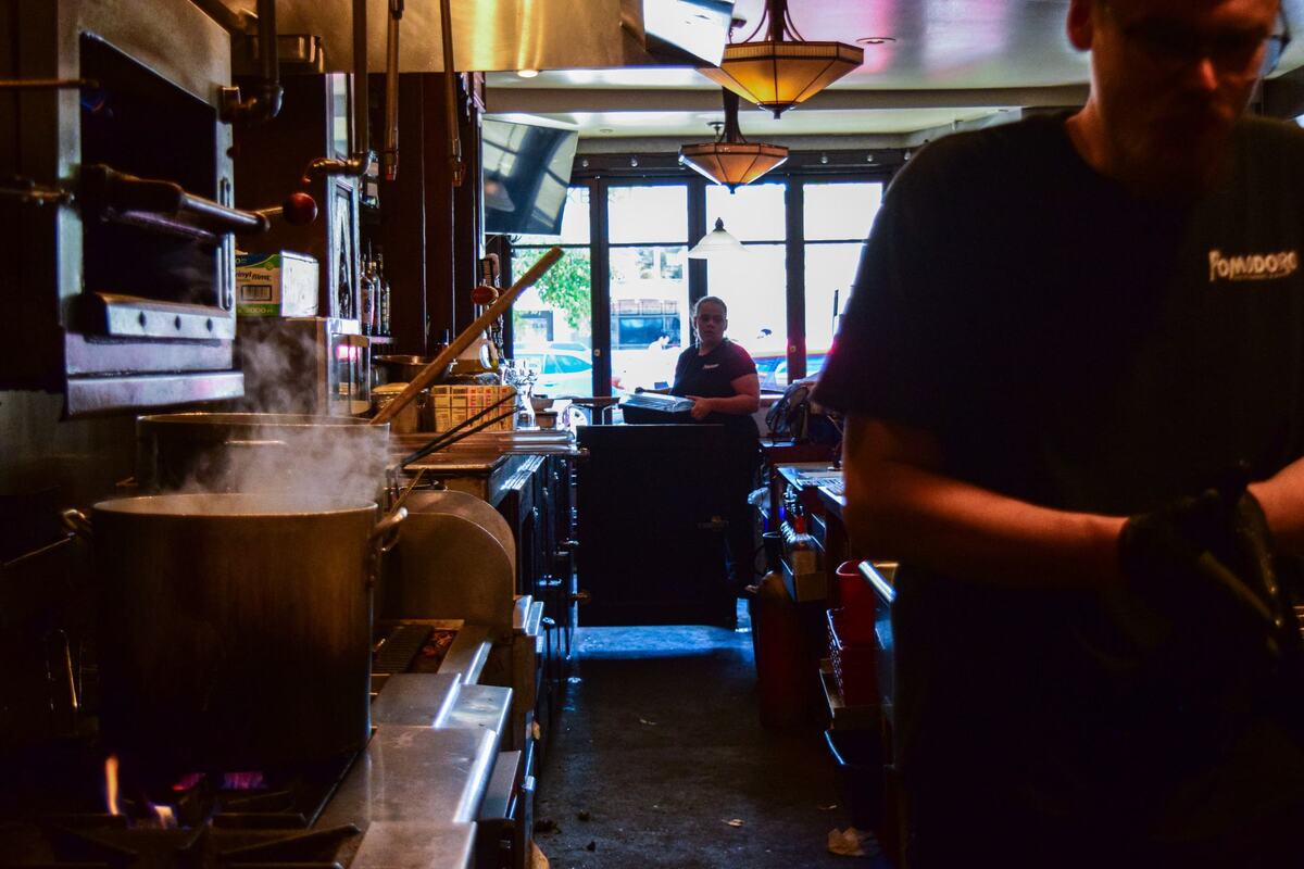 Pomodoro staff prep for lunch service on July 13, 2024. A new restaurant, Corbeau, will retain the bar and much of the layout.