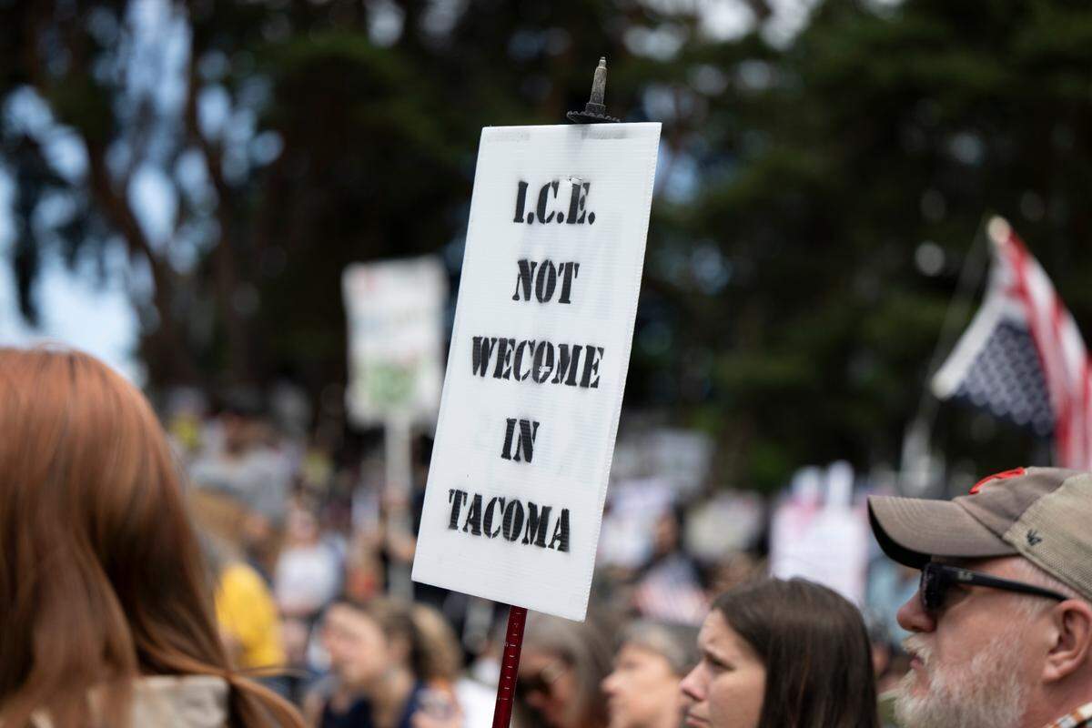 A person waves an anti-ICE sign during a “No Kings” protest at People’s Park on Saturday, June 14, 2025, in Tacoma, Wash. 