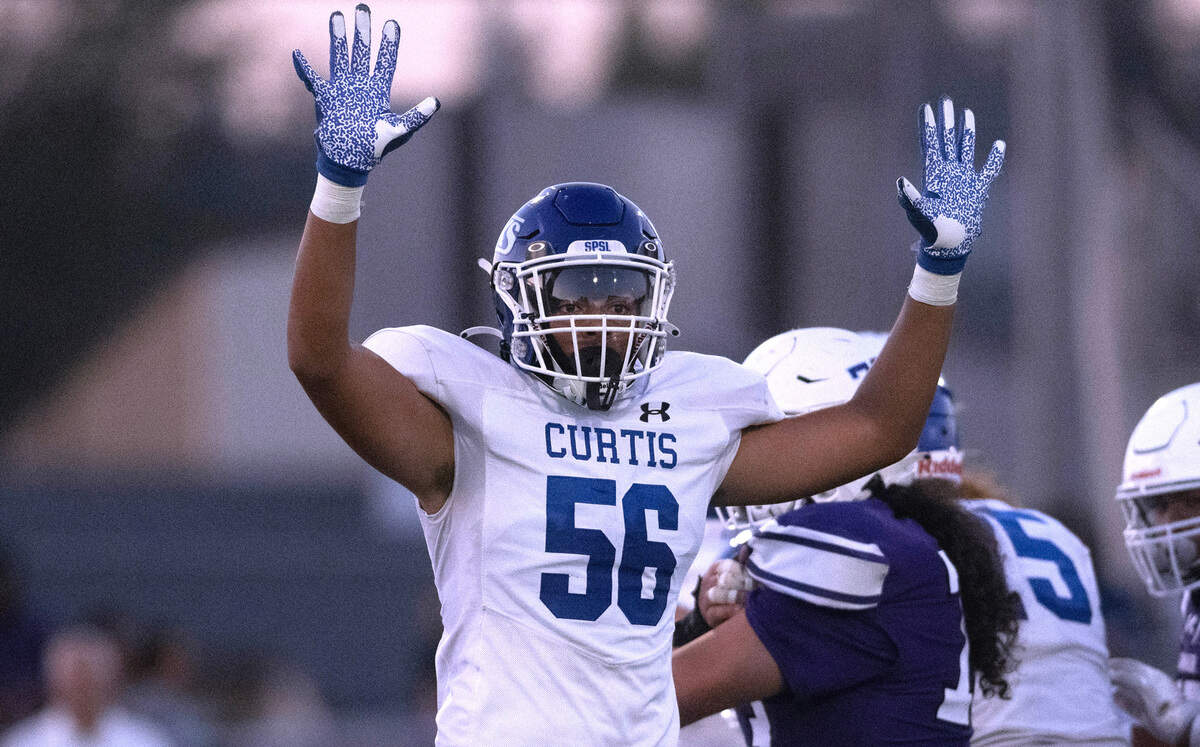 Curtis lineman Kingston Kirkhoff signals a Vikings touchdown during Friday night’s football game against the Sumner Spartans at Sunset Chevy Stadium in Sumner, Washington, on Sept. 8, 2023. Curtis won the game, 38-33.