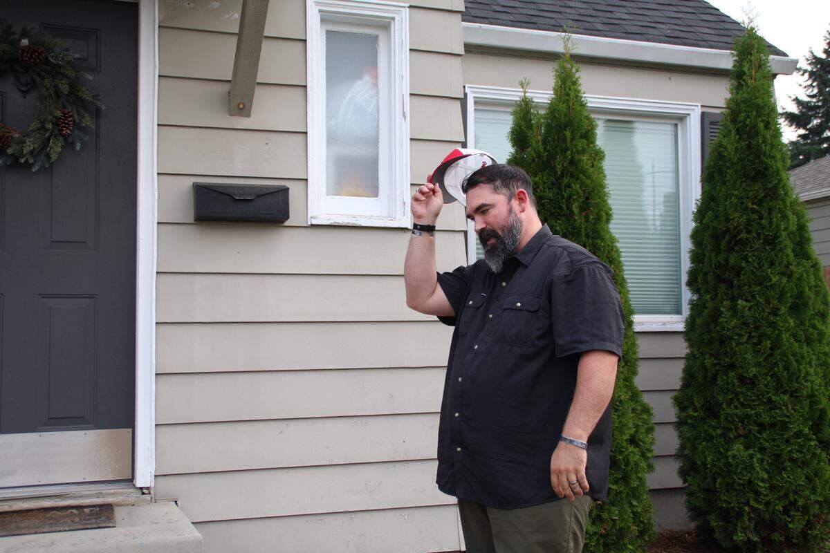 Edward “Jack” Barry, 37, reenacts part of his July 1 arrest outside his Tacoma home when U.S. Marshals arrested him as a fugitive out of Portland for a 2022 robbery he didn’t commit. Pictured on Friday, Sept. 5, 2025.