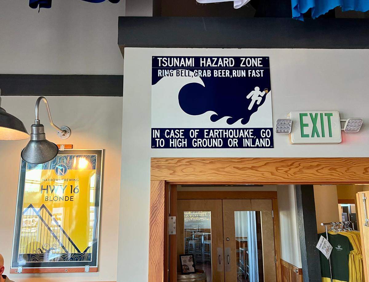 A sign warning of tsunami hazard is pictured at Narrows Brewing Company in Tacoma on Sept. 16, 2024.