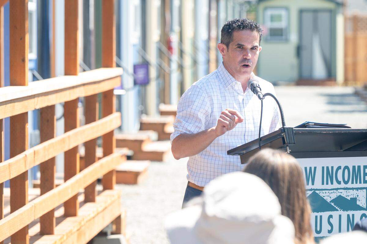 Pierce County Executive Ryan Mello speaks at the grand opening event for Kingfisher Village, a new collection of tiny homes operated by the Low Income Housing Institute, on Wednesday, July 23, 2025, in Tacoma, Wash.