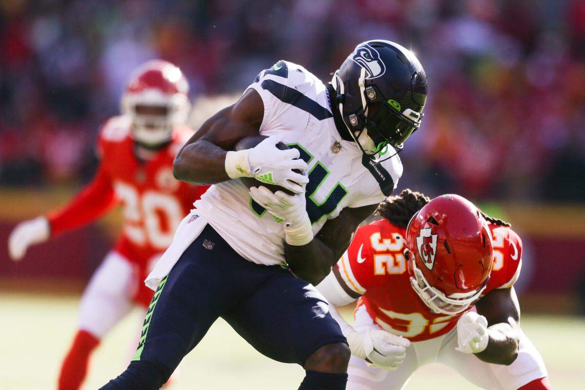 Seattle Seahawks wide receiver DK Metcalf (14) is tackled by Kansas City Chiefs linebacker Nick Bolton (32) during the first quarter on Saturday, Dec. 24, 2022, in Kansas City, MO.
