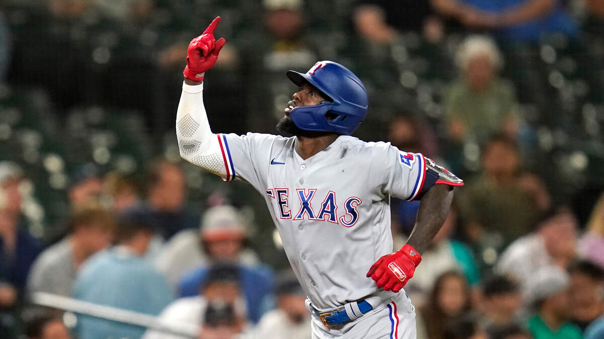 Texas Rangers’ Adolis Garcia motions as he heads home on a solo home run against the Seattle Mariners during the ninth inning of a baseball game Tuesday, Aug. 10, 2021, in Seattle. (AP Photo/Elaine Thompson)