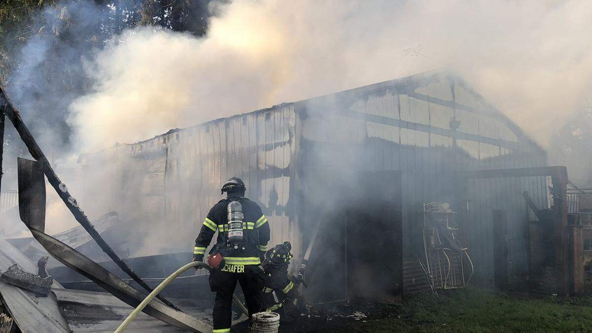 Firefighters respond to a barn fire Nov. 12, 2018 in the 12900 block of Southeast 203rd Place in Kent. Seven horses died in the blaze.