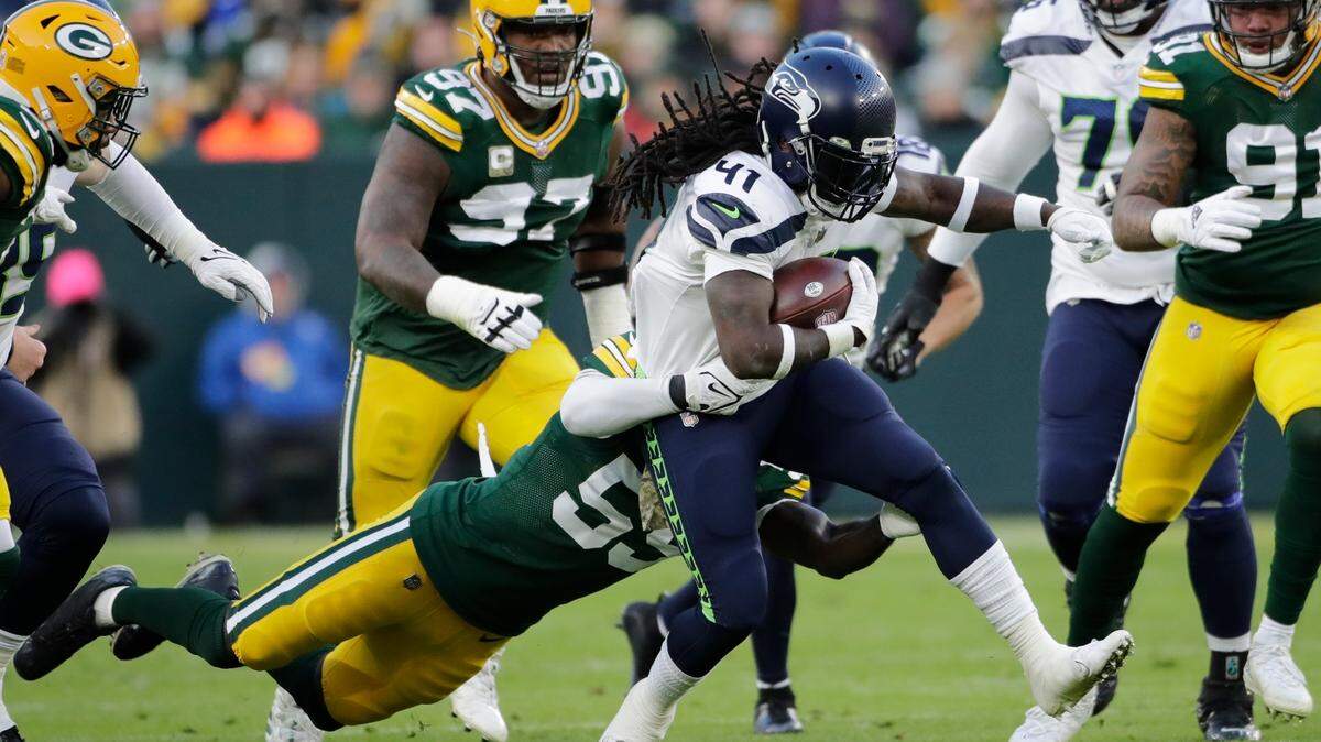 Seattle Seahawks’ Alex Collins runs during the first half of an NFL football game against the Green Bay Packers Sunday, Nov. 14, 2021, in Green Bay, Wis. (AP Photo/Aaron Gash)