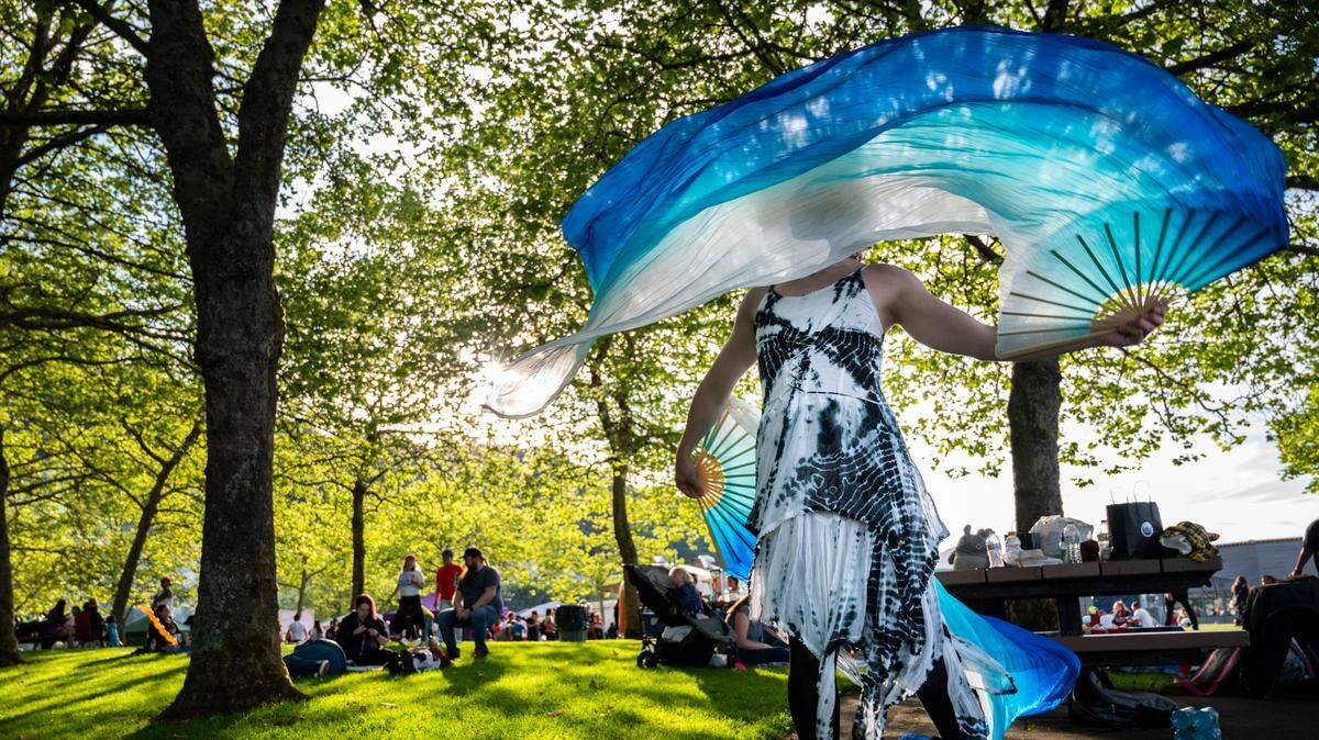 Spirit Patterson dances with her silk fans in Cummings Park during Tacoma’s 4th of July Summer Blast in Tacoma on July 4, 2022.