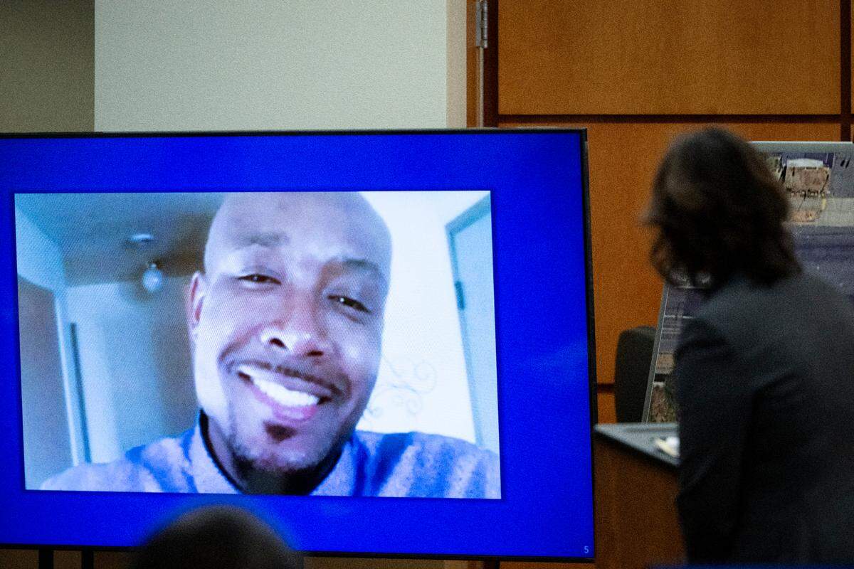 A photo of Manny Ellis is displayed while special prosecutor Patty Eakes gives closing arguments during the trial of three Tacoma police officers in the killing of Manny Ellis at Pierce County Superior Court, Dec. 11, 2023.
