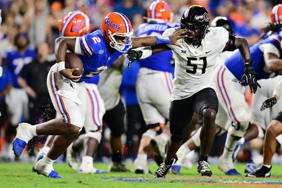 GAINESVILLE, FLORIDA - OCTOBER 05: DJ Lagway #2 of the Florida Gators stiff arms Malachi Lawrence #51 of the UCF Knights in the fourth quarter of a game at Ben Hill Griffin Stadium on October 05, 2024 in Gainesville, Florida. (Photo by Julio Aguilar/Getty Images)