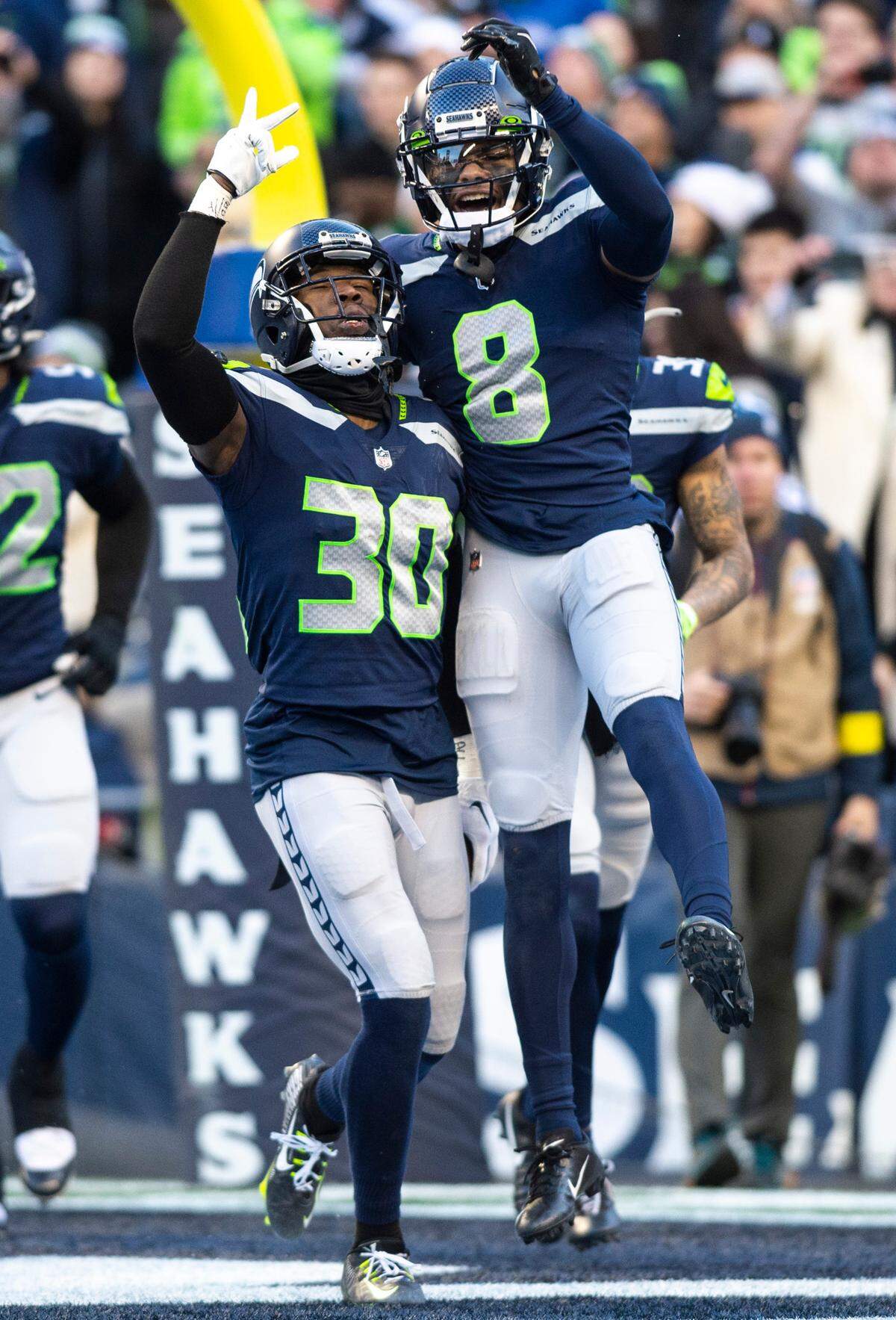 Seattle Seahawks cornerback Mike Jackson (30) celebrates with Seattle Seahawks cornerback Coby Bryant (8) after intercepting a pass from New York Jets quarterback Mike White (5) in the fourth quarter of an NFL game at Lumen Field in Seattle Wash. on Jan. 1, 2023. The Seahawks defeated the Jets 23-6.