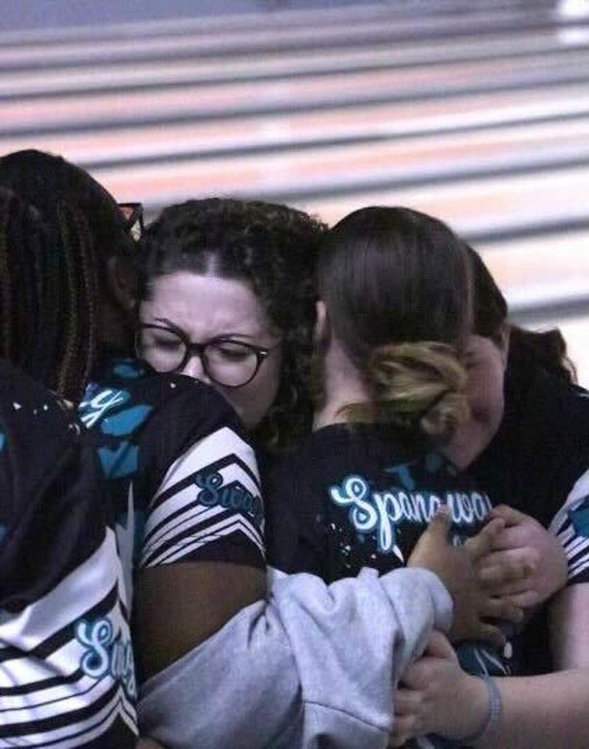 Teammates embrace and congratulate Spanaway Lake’s Tamia Yeager after the senior bowled her first-career perfect 300 game on Dec. 19, 2024, at Paradise Lanes in Tacoma.