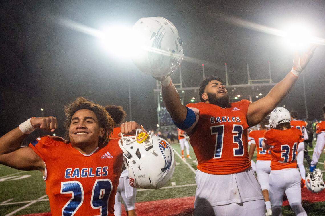 Graham Kapowsin’s Alele Faapito-Leao (29) and Vega Ioane (73) relish in the cheers of the Eagle’s fans after helping their team to a 44-7 win over Lake Stevens in the State 4A championship game on Saturday afternoon at Mount Tahoma Stadium in Tacoma.
