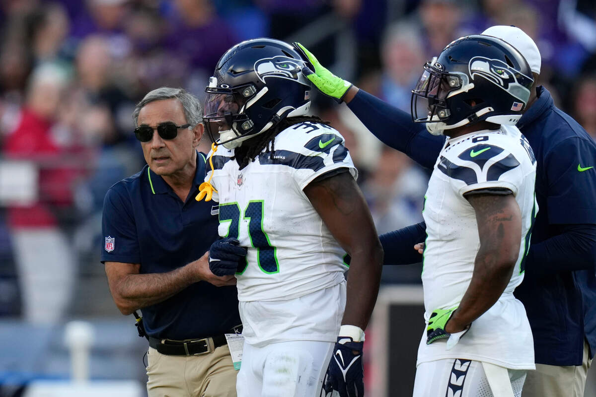 Seattle Seahawks running back DeeJay Dallas (31) is helped off the field after getting injured during the second half of an NFL football game against the Baltimore Ravens, Sunday, Nov. 5, 2023, in Baltimore. (AP Photo/Alex Brandon)