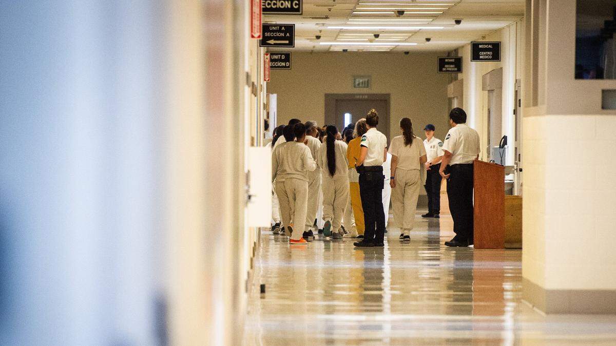A group of detainees are led down a hallway during a media tour of the Northwest ICE Processing Center in this 2020 file photo.