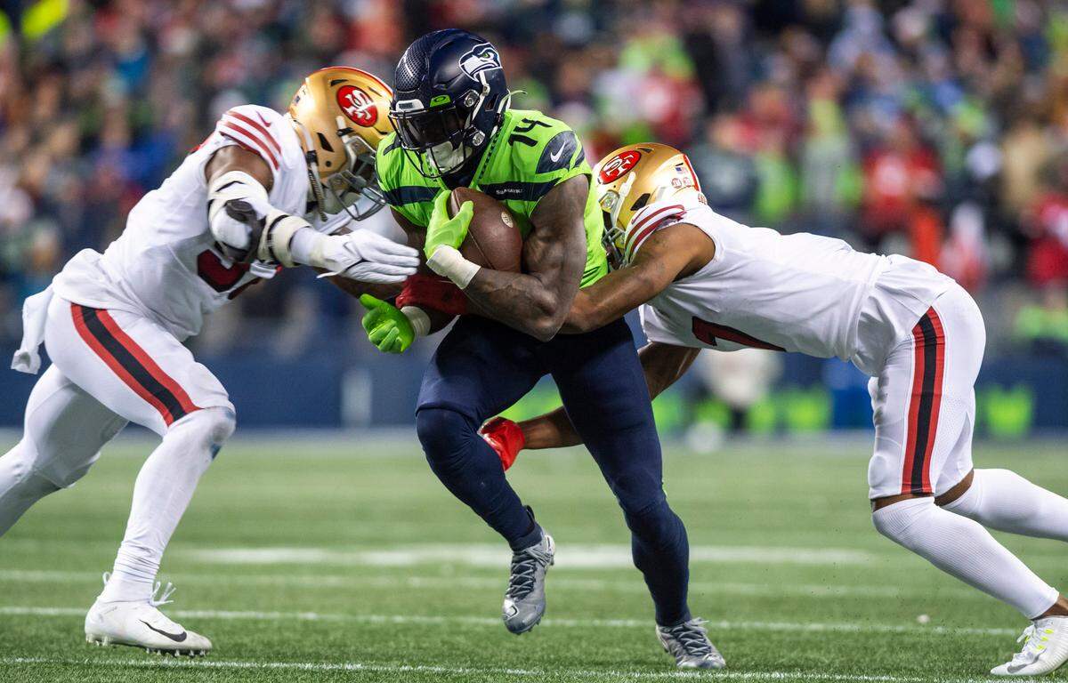 Seattle Seahawks wide receiver DK Metcalf (14) is tackled by San Francisco 49ers linebacker Dre Greenlaw (57) and San Francisco 49ers cornerback Charvarius Ward (7) in the third quarter of an NFL game at Lumen Field in Seattle Wash. on Dec. 15, 2022.