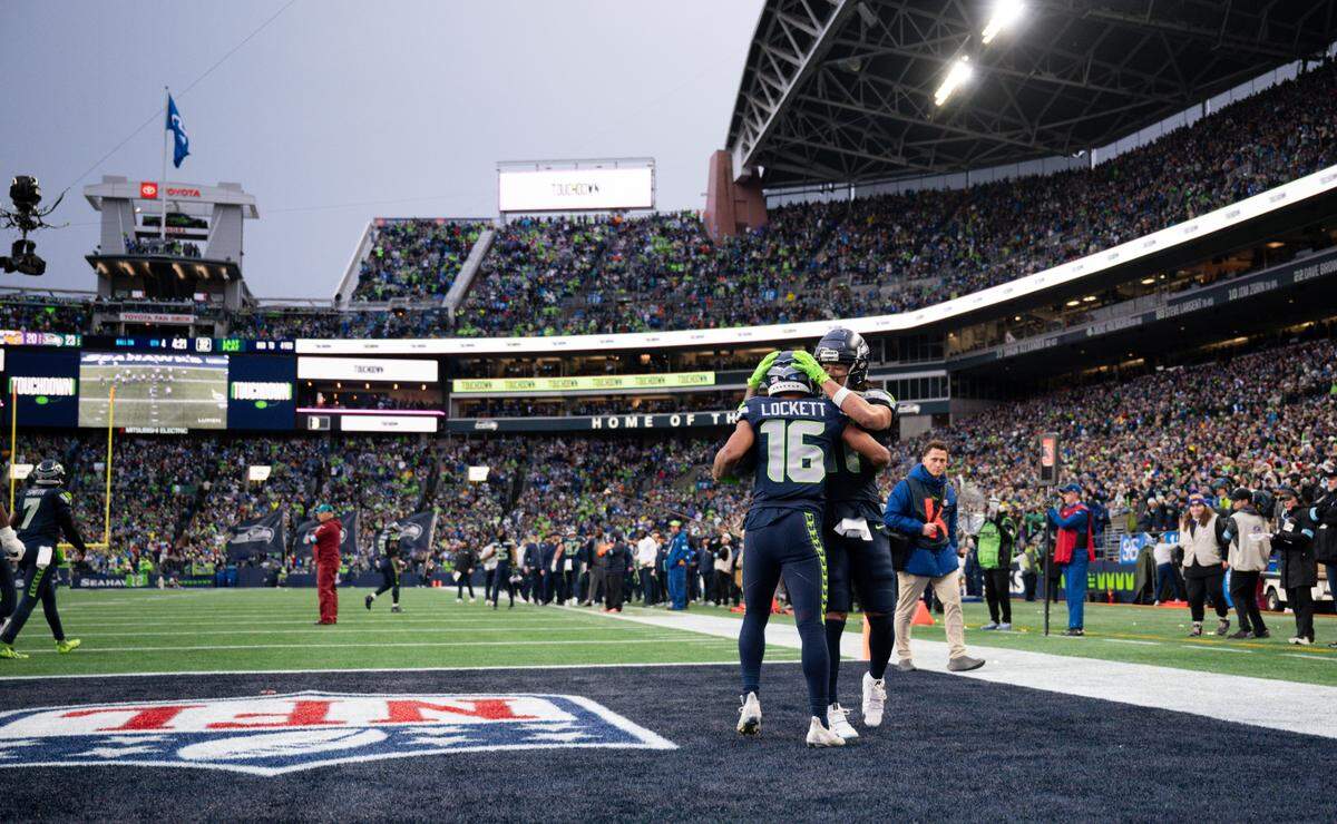 Seattle Seahawks wide receiver Tyler Lockett (16) and wide receiver Jaxon Smith-Njigba (11) reacts to a touchdown from tight end AJ Barner (88) during the fourth quarter of the game against the Minnesota Vikings at Lumen Field, on Sunday, Dec. 22, 2024, in Seattle, Wash.