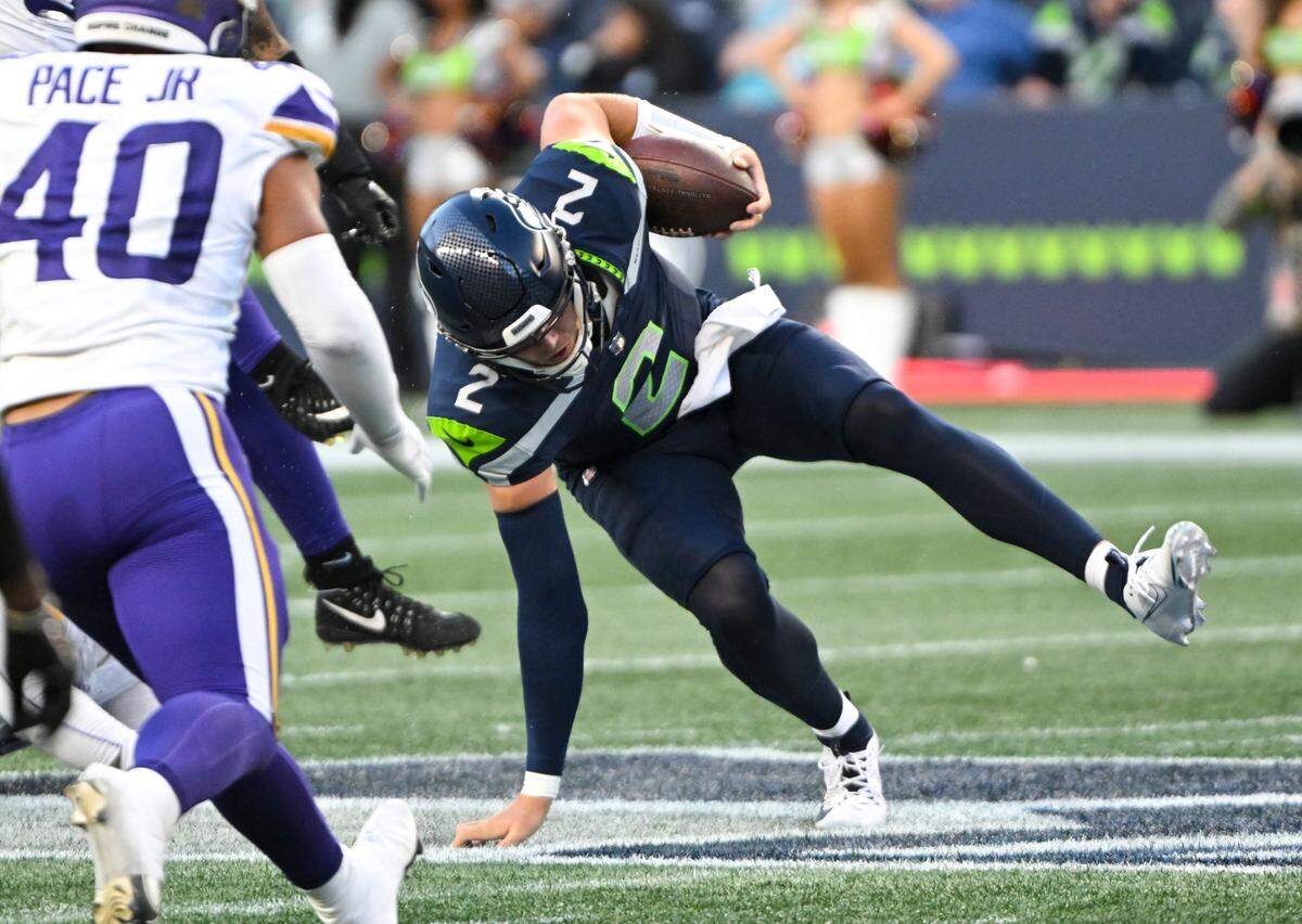 Seattle Seahawks quarterback Drew Lock (2) stumbles while running the ball against the Minnesota Vikings during the second quarter of the preseason game at Lumen Field, Thursday, Aug. 10, 2023, in Seattle, Wash.